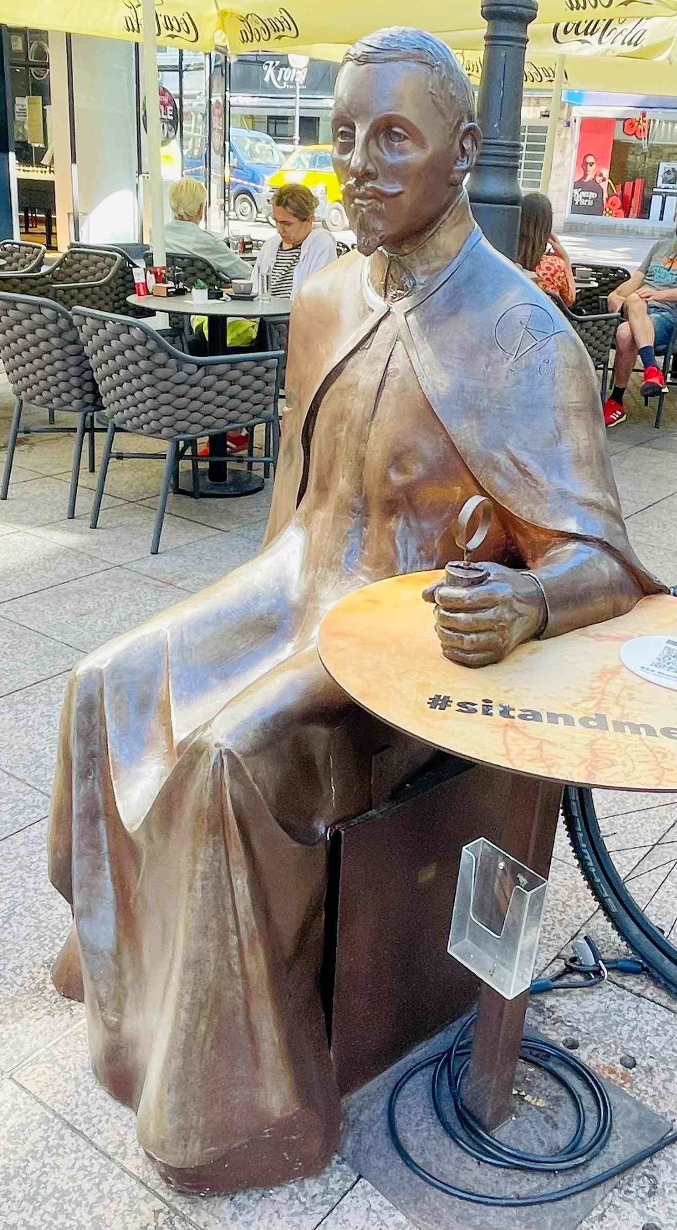 Another statue in Zagreb, Croatia of a man sitting at a table